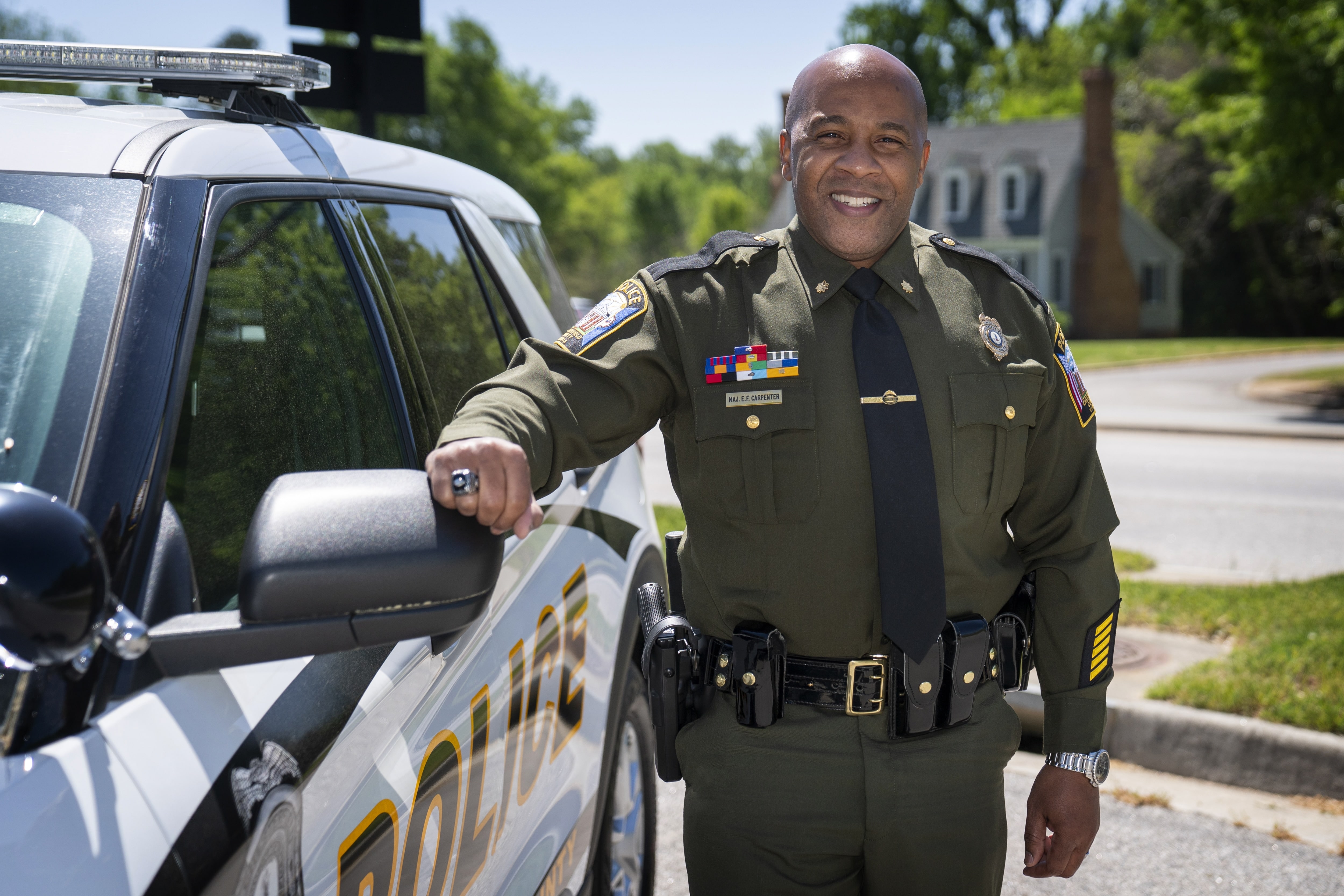 Policeman standing next to police car