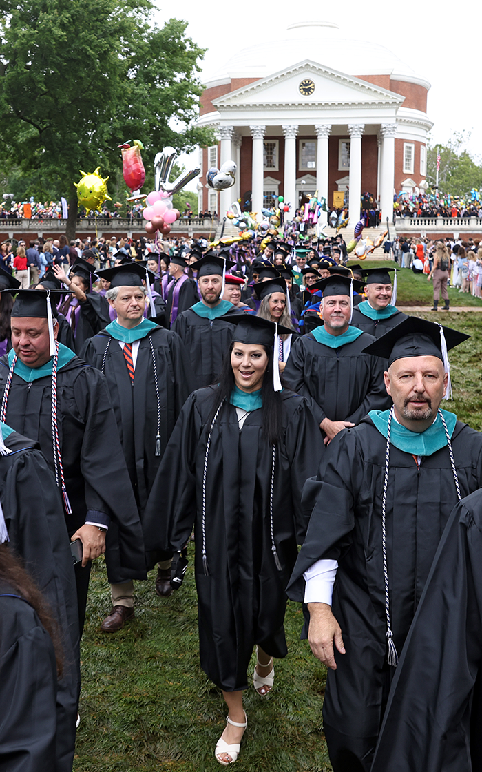 Afsoon Ansari walking across the lawn during graduation