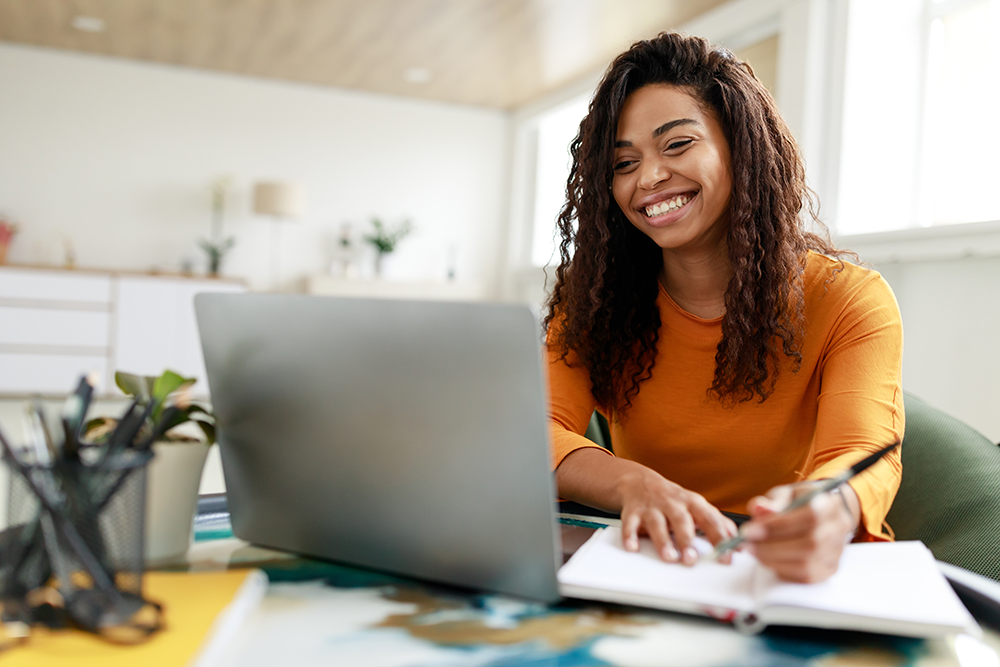 Woman smiling while working on computer