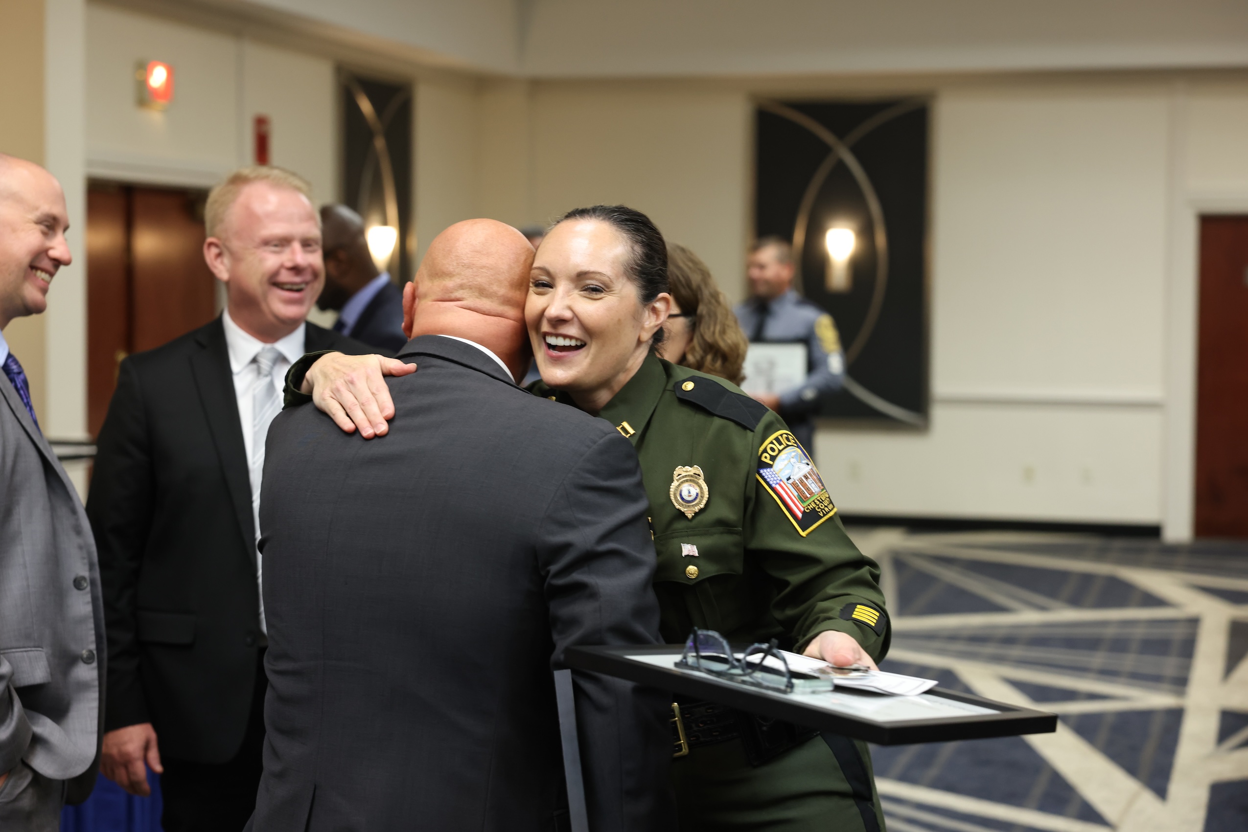 Woman in uniform hugging a man