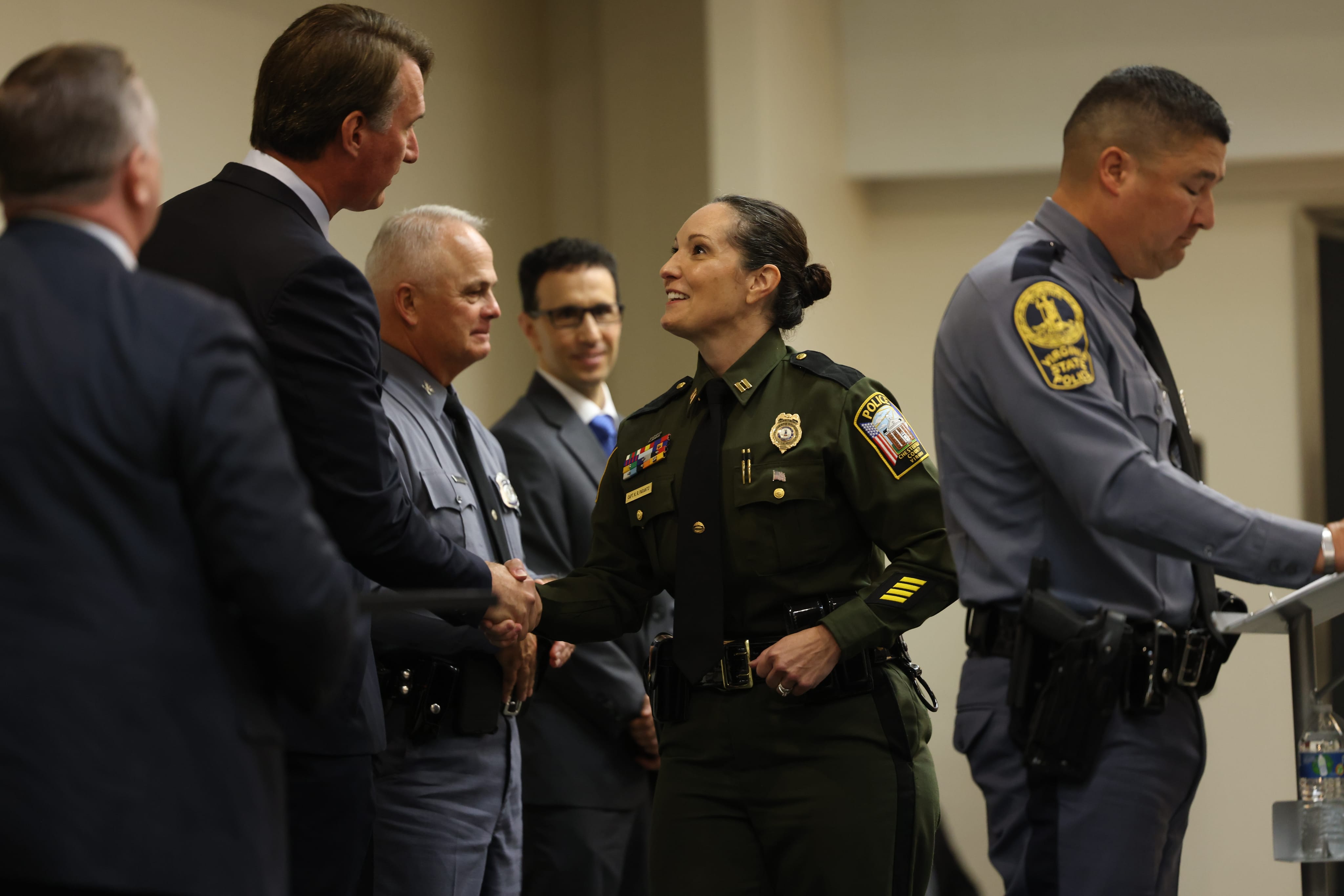 A police woman shaking hands with someone